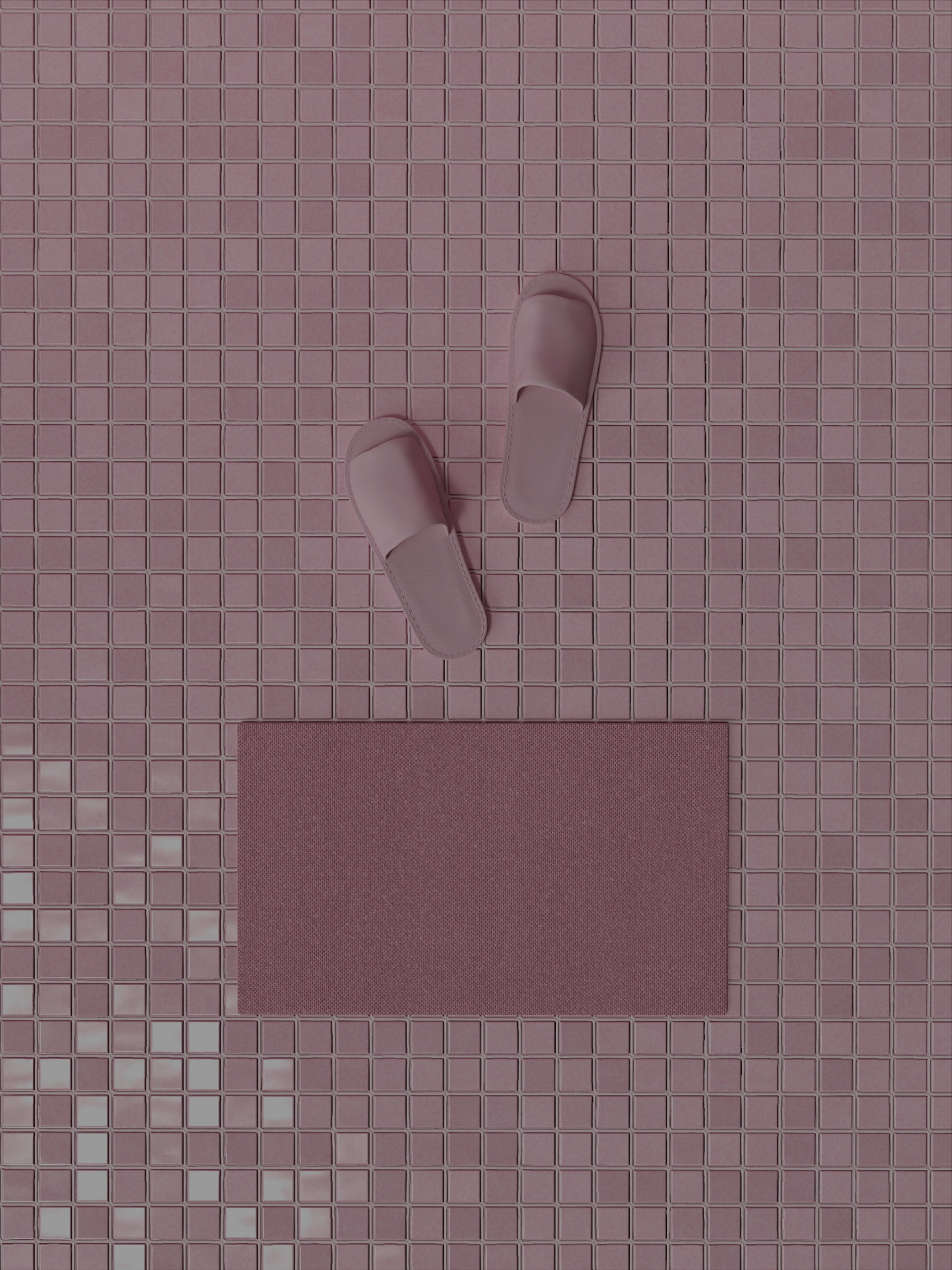 Pink slippers and a bathmat on a pink tiled floor.