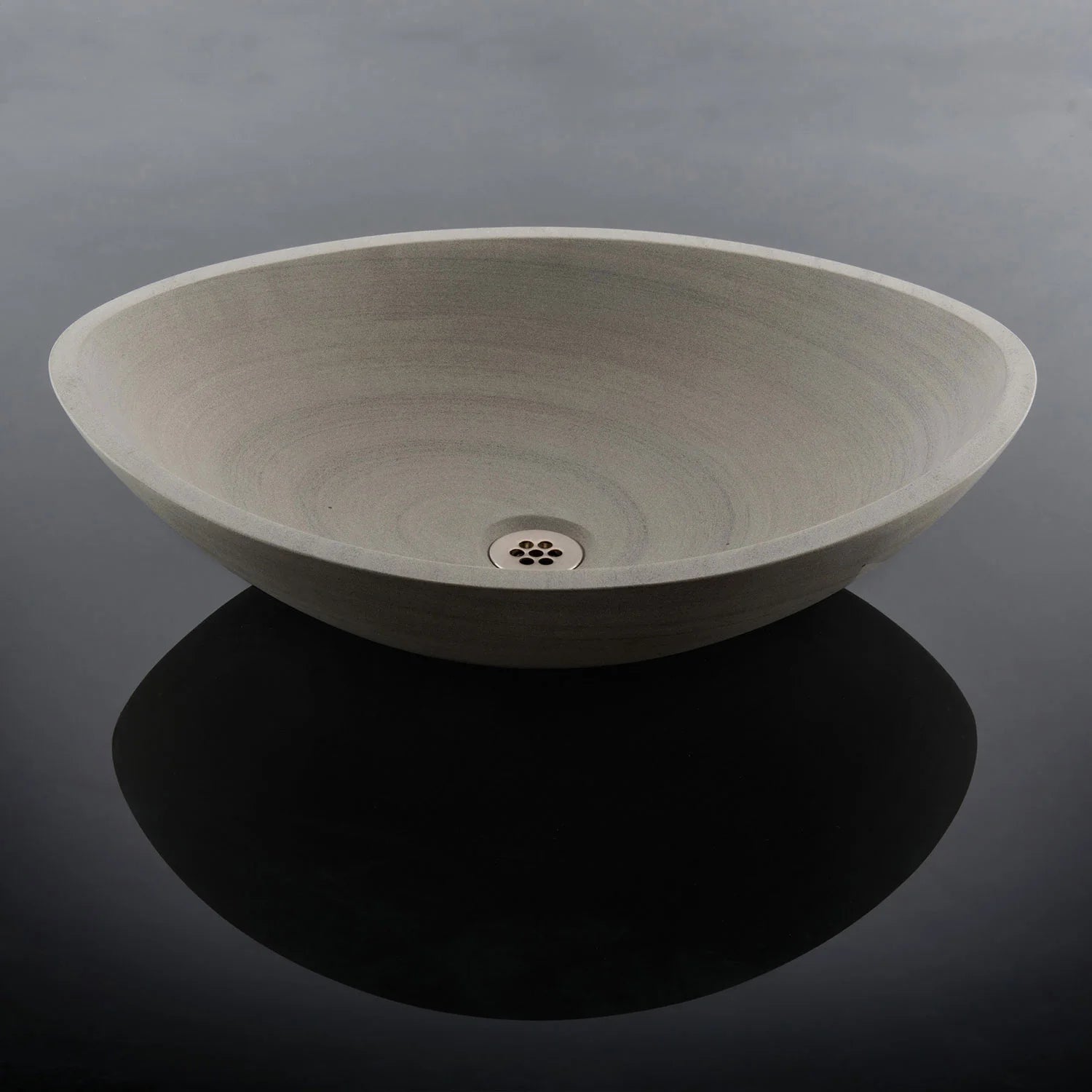 sandstone vessel sink on black surface