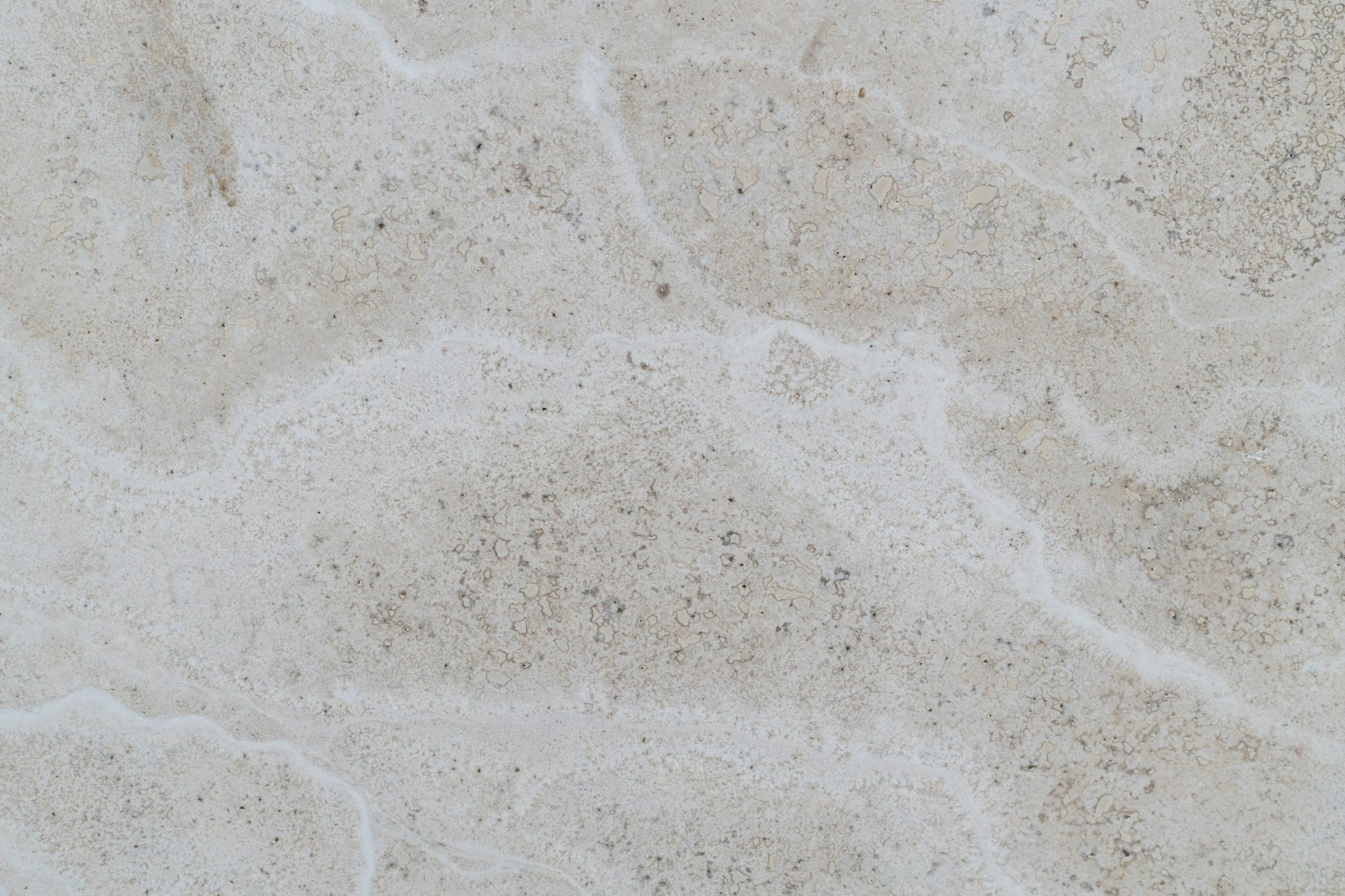A close up view of a white and beige marble surface.