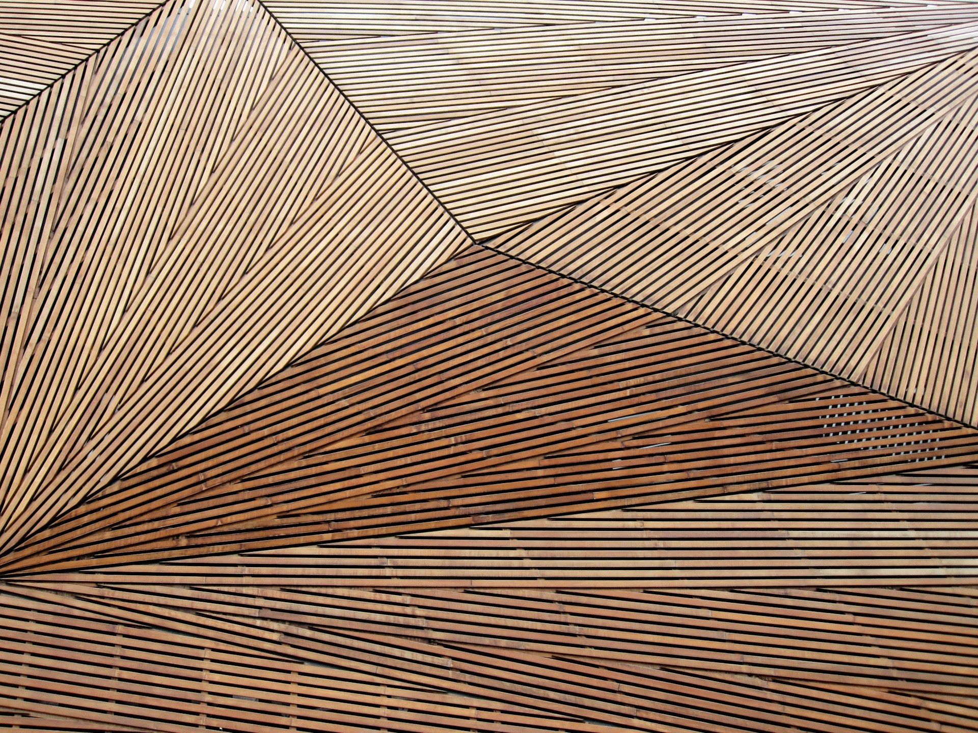 A close up of a wood slatted surface with a geometric pattern.
