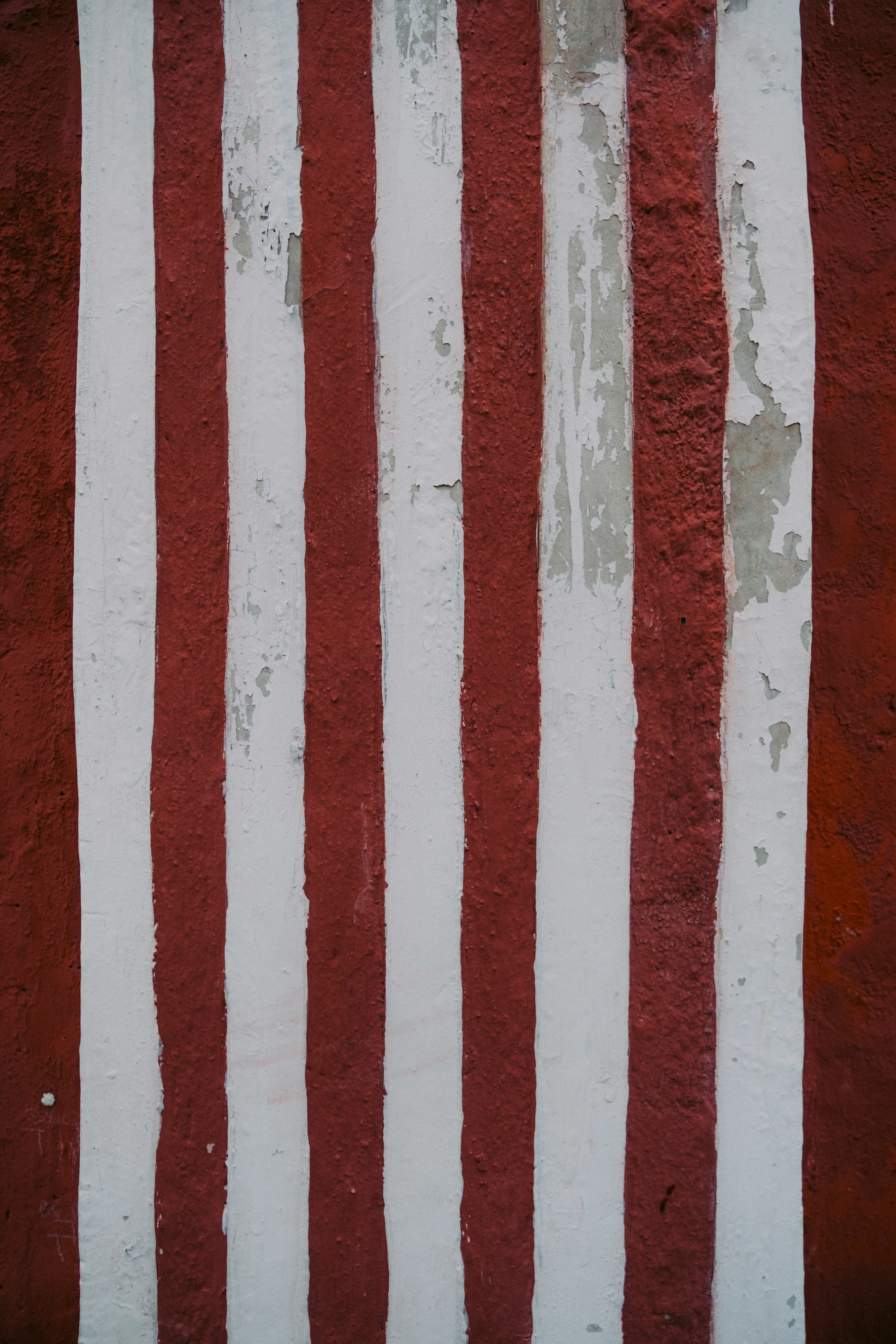 An aged red and white striped wall.