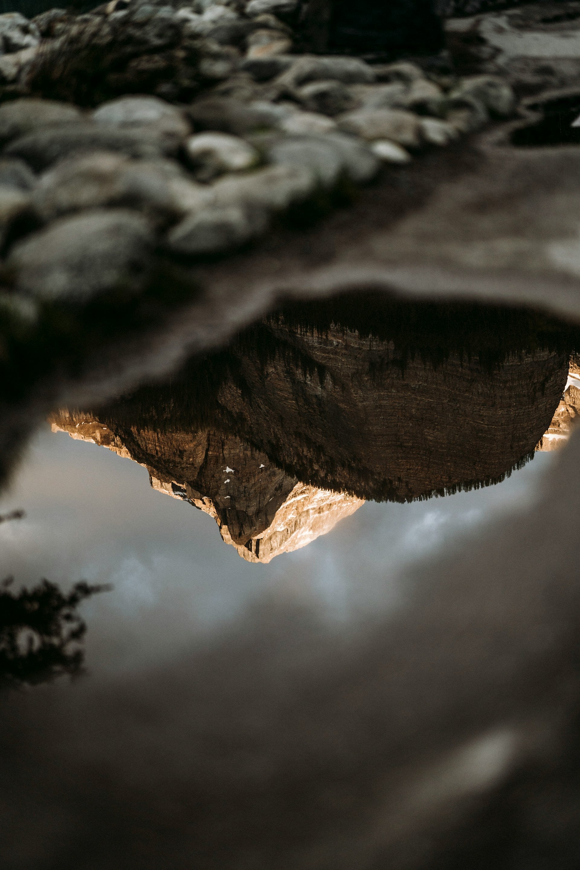 A reflection of a mountain in a puddle of water.
