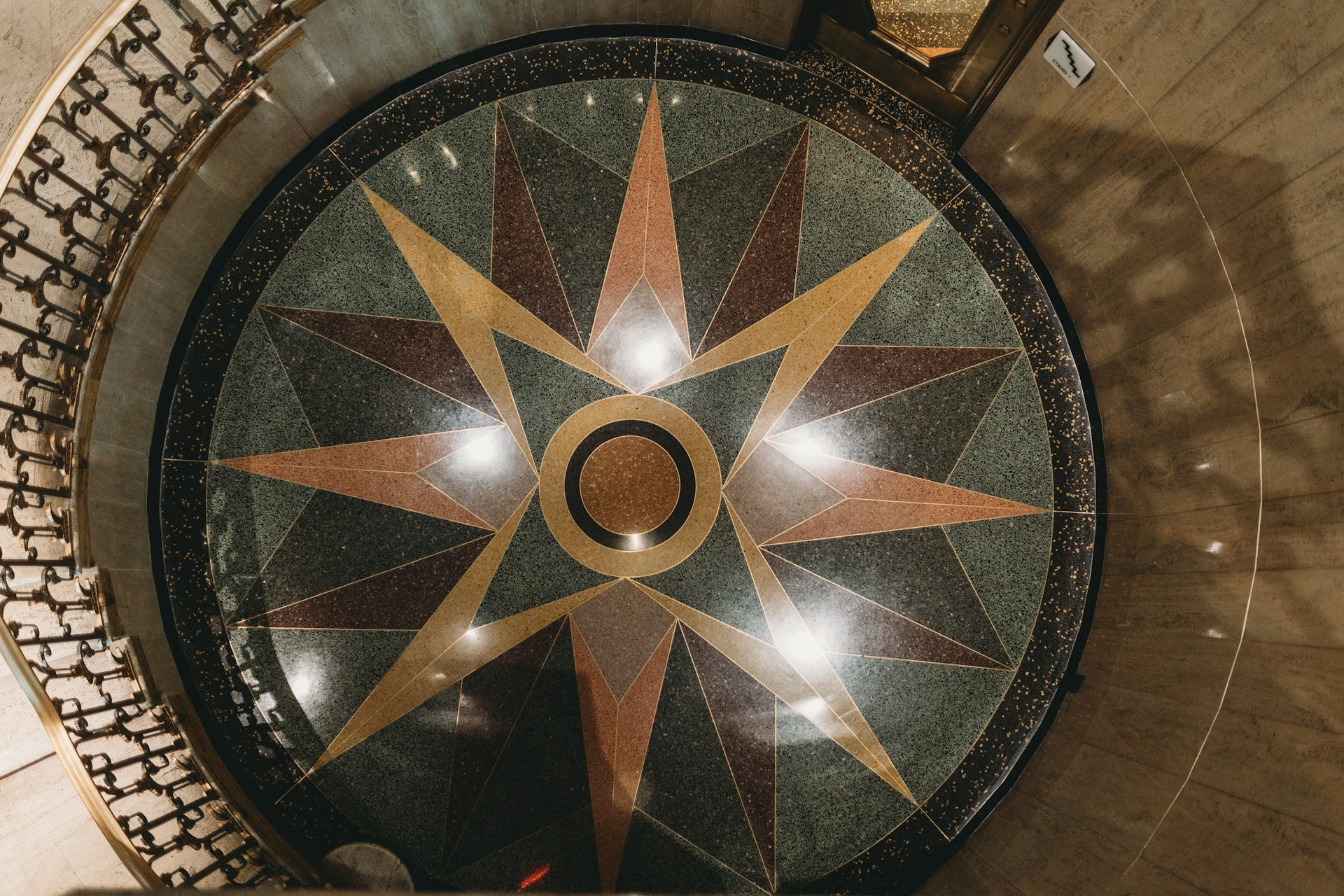 A circular marble floor with a star pattern on it.
