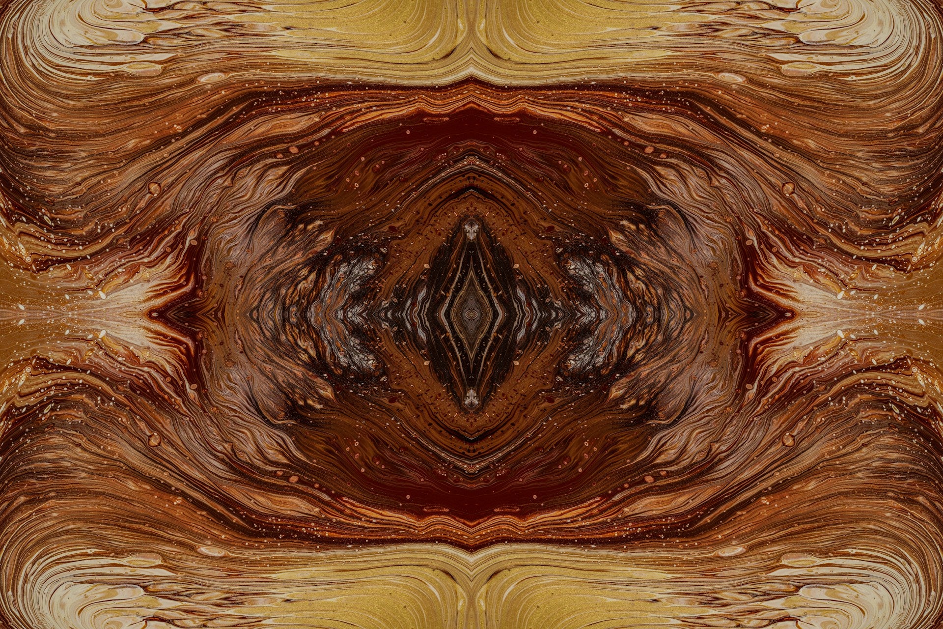 A mirrored abstract image with brown and yellow colors.