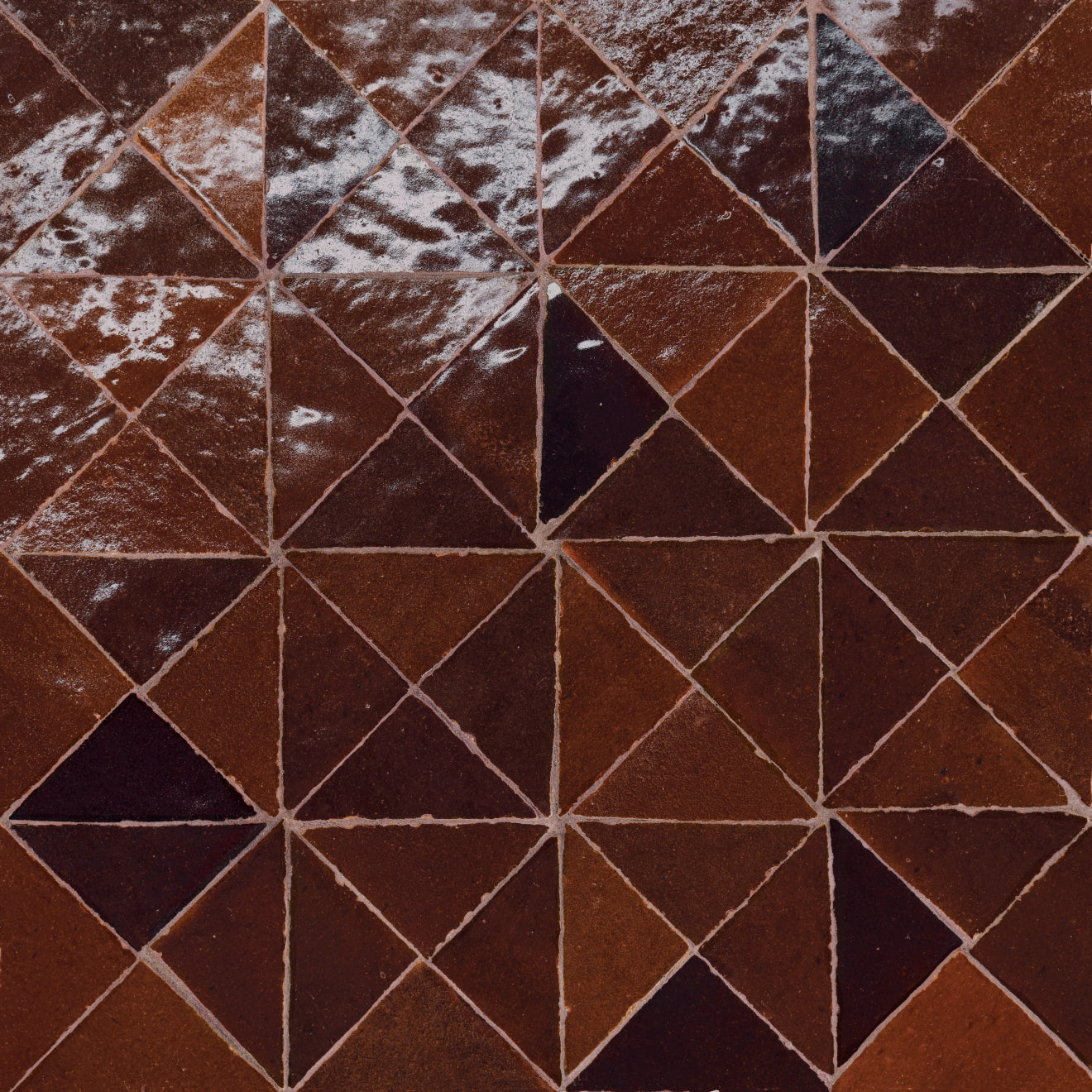 Brown and red tone geometric tiles.