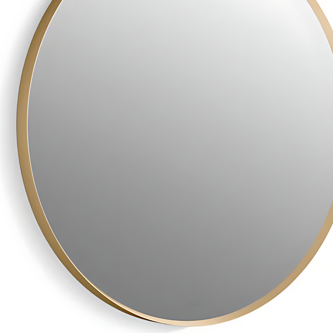 A round mirror with a gold frame.
