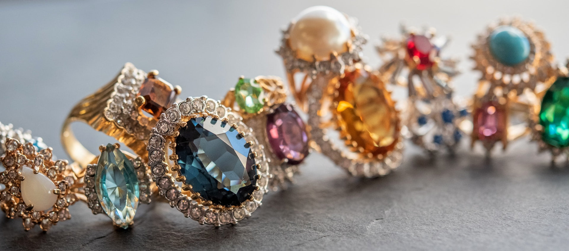 Colorful diamond and crystal rings placed in a row.