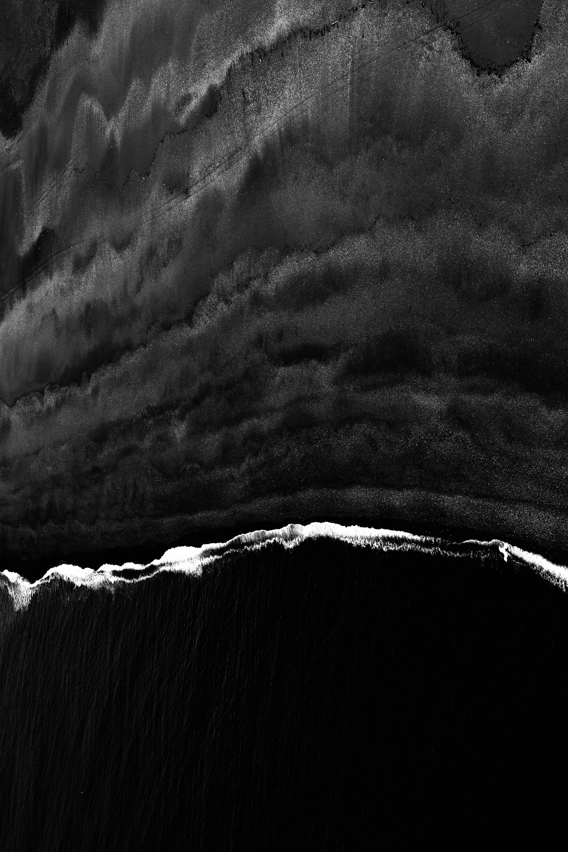 A black and white photo of a wave in the ocean.