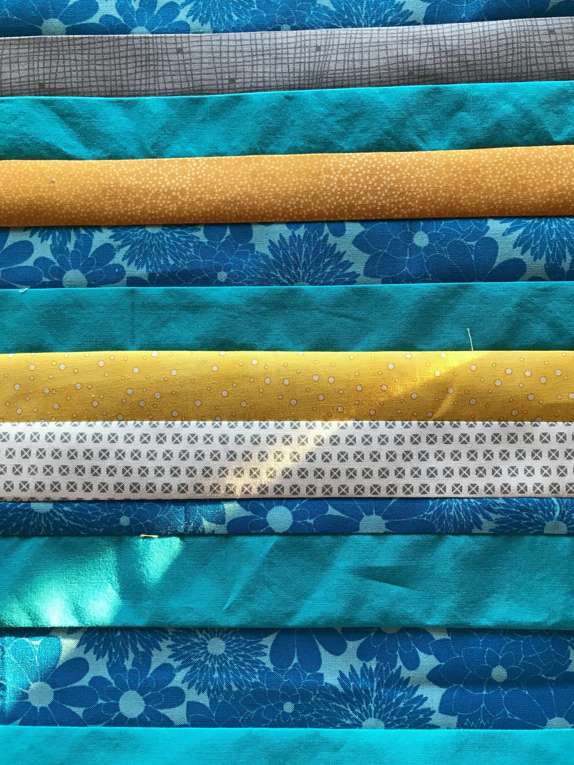 A close up of blue, yellow and white fabric.