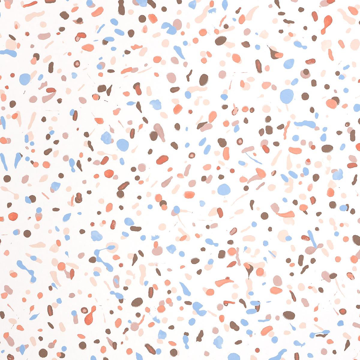 Red and blue splatters of paint on a white surface.