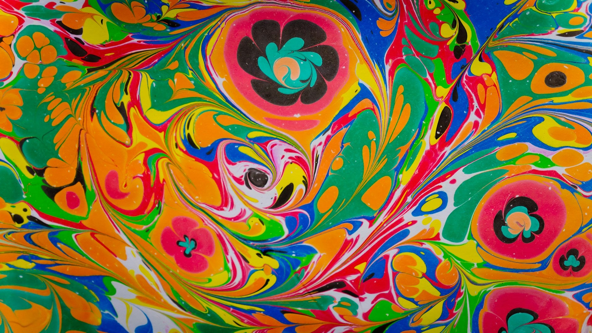 Colorful paint swirled into a floral, abstract pattern.